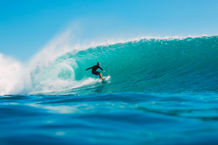 July 7, 2018. Bali, Indonesia. Surfer ride on a big barrel wave at Padang Padang. Professional...