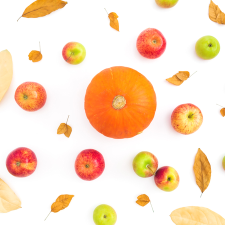Thanksgiving autumn background with fall dried leaves, apples and pumpkin on white background. Flat lay, top viewの写真素材