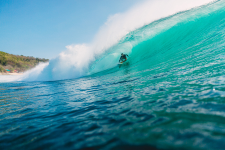 July 29, 2018. Bali, Indonesia. Surfer ride on barrel wave. Professional surfing in the ocean at big wavesのeditorial素材