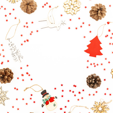 Christmas decoration, confetti and pine cones on white. Flat lay, top view. New Year frame conceptの写真素材