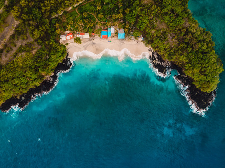 White sand beach with coconut palms and crystal blue ocean in Bali. Aerial viewの写真素材