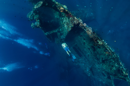 Free diver man dive at shipwreck, underwaterの写真素材