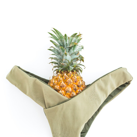 Tropical woman concept. Pineapple fruit and bikini on white background. Flat lay, top view.の写真素材