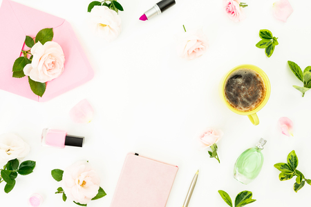Composition with flowers, pink envelope, coffee mug, cosmetics and aroma on white background. Flat lay, top view. Woman day copy space conceptの写真素材