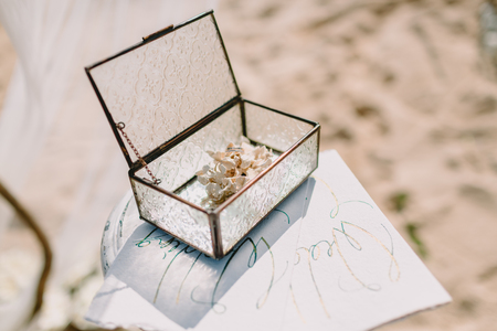 Wedding rings in glass box. Wedding ceremony.
