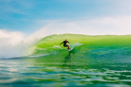 April 24, 2019. Bali, Indonesia. Surfer ride on barrel wave. Professional surfing at Dreamland beachのeditorial素材