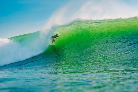 April 24, 2019. Bali, Indonesia. Surfer ride on barrel wave. Professional surfing at Dreamland beach