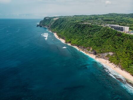 Aerial view of coastline with tropical beach and blue ocean in Bali