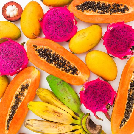 Fruits background with banana, papaya, mango and dragon fruits. Flat lay. Top view. Tropical foodの写真素材