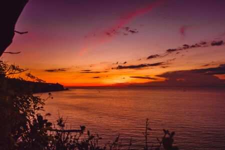 Bright colorful sunset or sunrise with oceanの写真素材