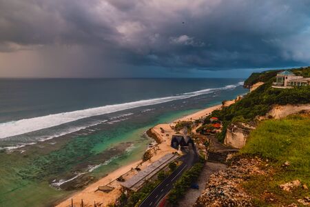 Aerial view of ocean coast with waves and warm sunset or sunrise.の写真素材