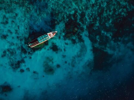 Tour boat in blue ocean in Gili island. Aerial view.の写真素材