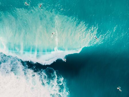 Aerial view of surfing at barrel waves. Blue waves in ocean and surfersの写真素材
