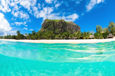 Tropical ocean with Le Morne mountain and beach in Mauritius.