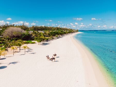 Luxury tropical beach in Mauritius. Sandy beach with palms and blue transparent ocean. Aerial viewの写真素材