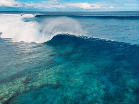 Blue barrel wave in tropical ocean. Aerial view of barrel wavesの写真素材