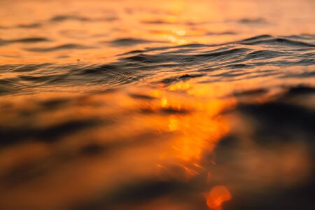 Sunset and waves in ocean.の写真素材