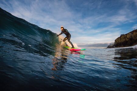 December 28, 2019. Anapa, Russia. Stand Up Paddle surfing on waves. SUP board and surfer in wetsuit...