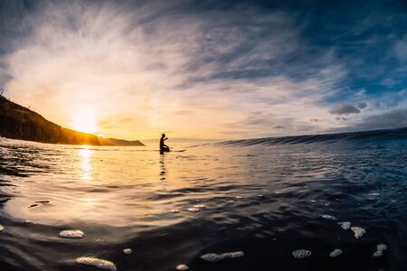 December 28, 2019. Anapa, Russia. Stand Up Paddle surfing on waves. SUP board and surfer in wetsuit...