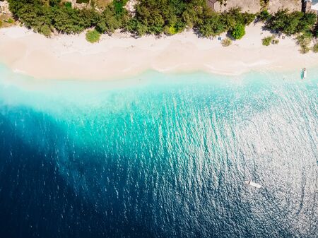 Tropical island with white sand beach and blue ocean. Aerial view.の写真素材