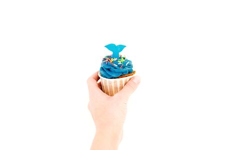 Blueberry muffins with cream in women hand on white background. Flat lay, top viewの写真素材