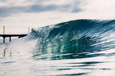 Barrel wave for surfing in ocean. Breaking transparent waveの写真素材