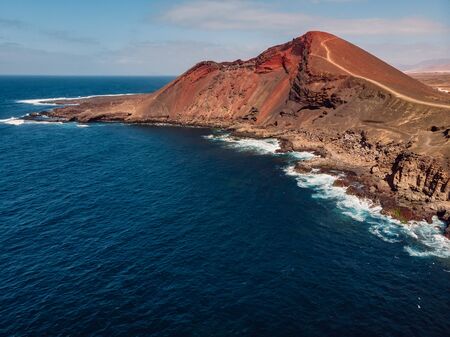 Volcanic crater with Atlantic ocean near La Santa, Lanzarote, Spain. Aerial view