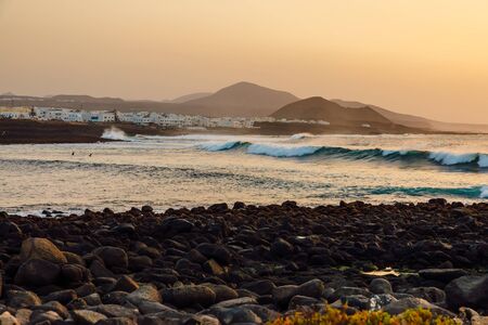La Santa beach with ocean wave at sunset in Lanzarote, Canary islandsの写真素材