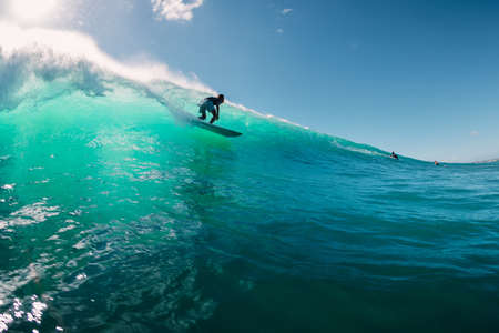 June 2, 2019. Bali, Indonesia. Surfer ride on barrel wave. Professional surfing at Padang Padangのeditorial素材