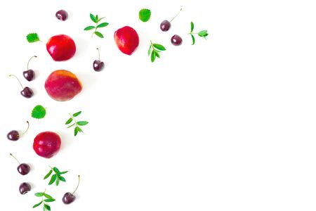 Peaches with cherry and mint leaves on white background. Summer food frame. Top view. Flat layの写真素材