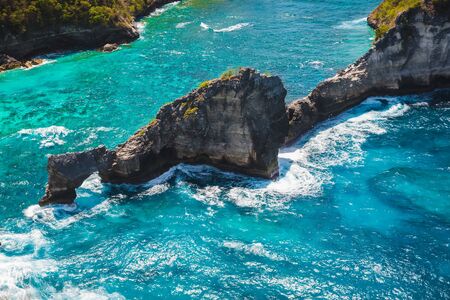 Rocks in blue ocean near Nusa Penida island. Bali, Indonesia.
