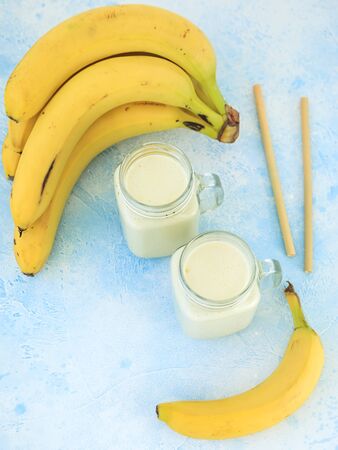 Healthy yogurt or smoothie with banana, vegetarian food, diet and health conceptの写真素材