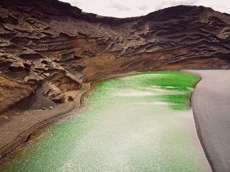 Volcanic crater with a green lake near El Golfo in Lanzarote island, Spainの写真素材