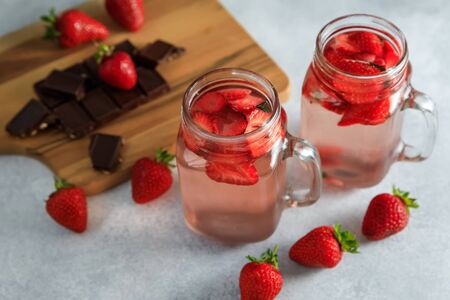 Strawberry drink with berriesand wooden board with chocolate. Diet drink and healthy conceptの写真素材
