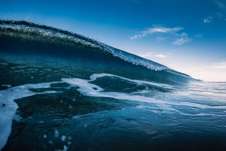 Blue barrel wave in ocean. Breaking sea wave