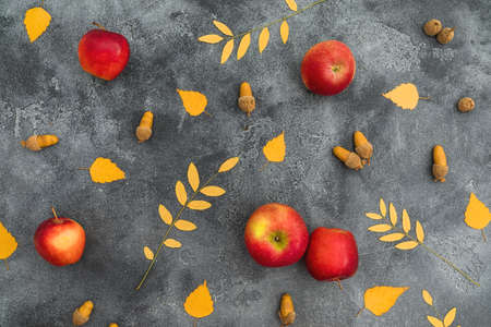 Autumn composition. Fall leaves, apple, cinnamon and acorns on dark background. Thanksgiving day concept. Flat lay, top viewの写真素材