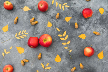 Thanksgiving day concept. Autumnal composition with fall leaves, apple and acorns on dark...
