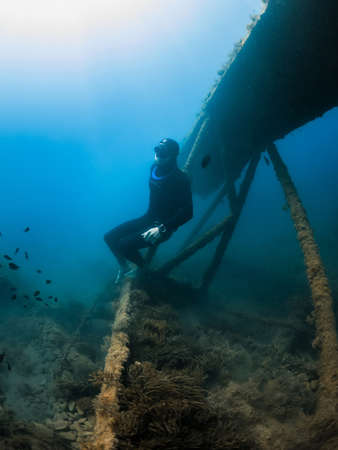 September 10, 2020. Anapa, Russia. Professional freediver in wetsuit and wreck underwater...