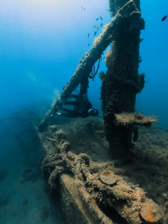 September 10, 2020. Anapa, Russia. Professional freediver in wetsuit and wreck underwater transparent sea.のeditorial素材