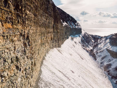Canyon with snow in winter. Aerial view of canyon with sunlightの写真素材