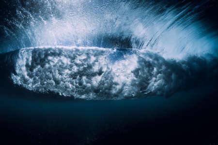 Breaking wave with foam and bubbles underwater. Transparent ocean waterの写真素材