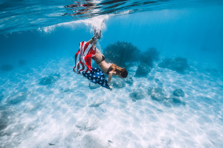 Woman freediver posing on sandy sea with fins. Free diving in Bahamasの写真素材