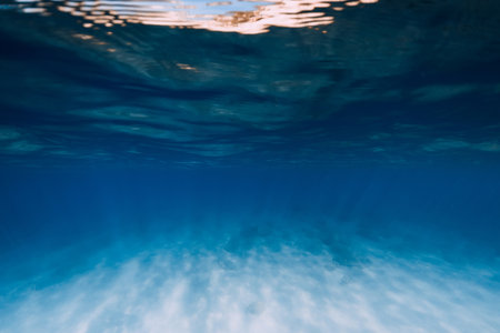 Tropical blue sea water in the deep with white sand bottom underwaterの写真素材