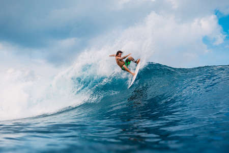January 21, 2021. Bali, Indonesia. Caucasian young surfer ride at ocean wave on the surfboard.のeditorial素材