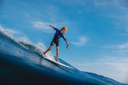 January 21, 2021. Bali, Indonesia. Caucasian young surfer ride at ocean wave on the surfboard.のeditorial素材