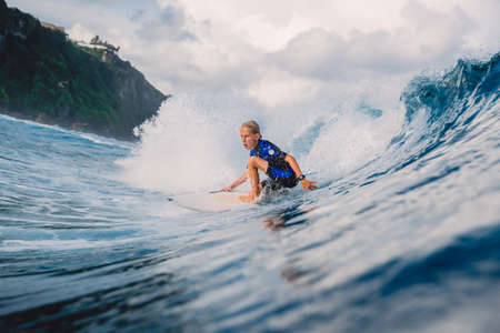 January 21, 2021. Bali, Indonesia. Caucasian young surfer ride at ocean wave on the surfboard.のeditorial素材