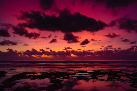 Colorful sunset or sunrise with clouds at beach in Bali.の写真素材