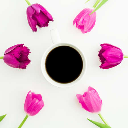Composition with tulips, roses and mug of coffee on white background. Flat lay, top view.の写真素材
