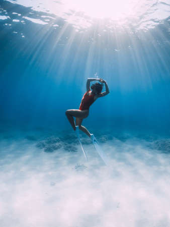 Free diver make ring bubble underwater. Sporty man freediver in summer seaの写真素材