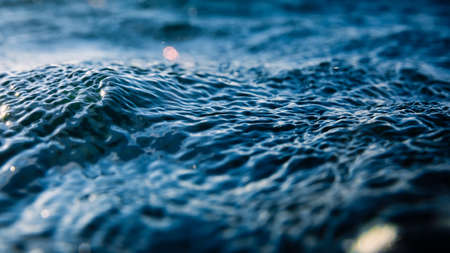 Water texture with sea waves, bokeh and drops.